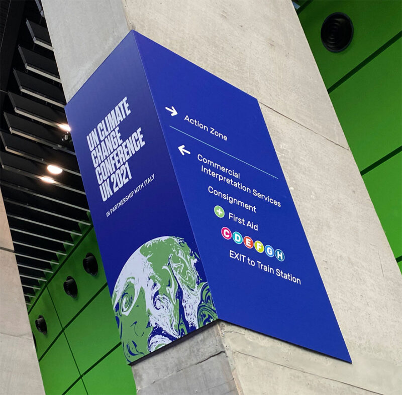 Interesting wayfinding signage applied to concrete buttress at COP26