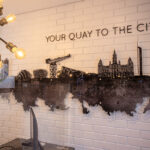 Feature wall created with CNC routered timber-painted panels and printed acrylic illustrating the Glasgow skyline