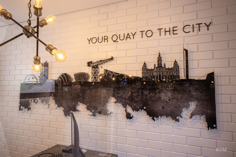 Feature wall created with CNC routered timber-painted panels and printed acrylic illustrating the Glasgow skyline