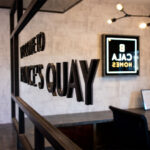 Laser-cut lettering bonded to mirror in marketing suite fitout